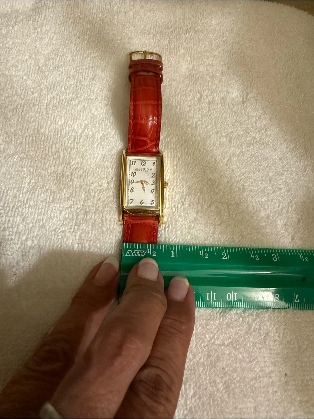 Clarins Gold-Tone Rectangular Watch with Red Strap and White Dial